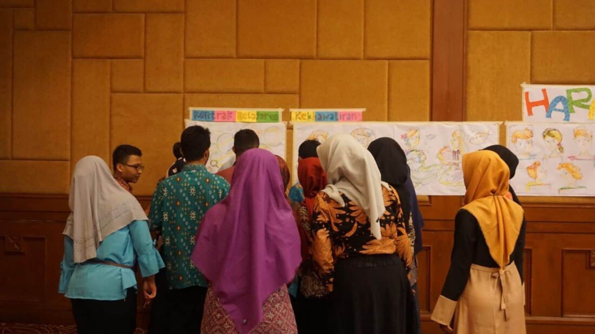 A team of muslim female tour guides at a company meeting.