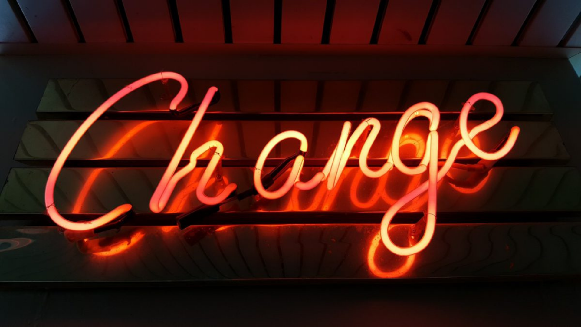 A neon sign that says 'change'