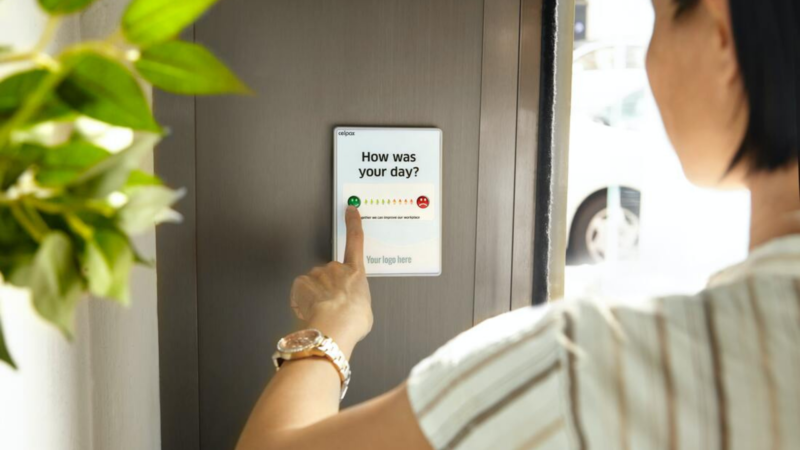 A customer gives feedback using a button on the wall